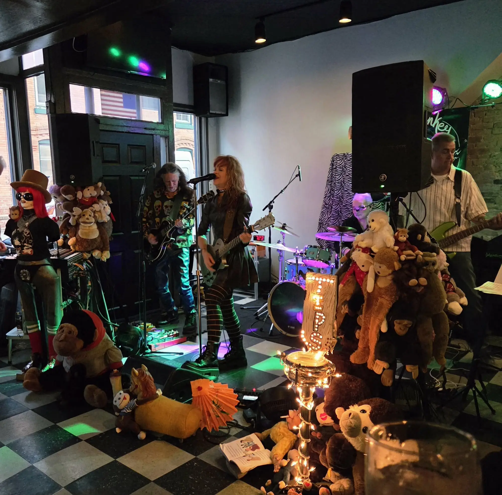 Band performing on stage at Tavern Off Main